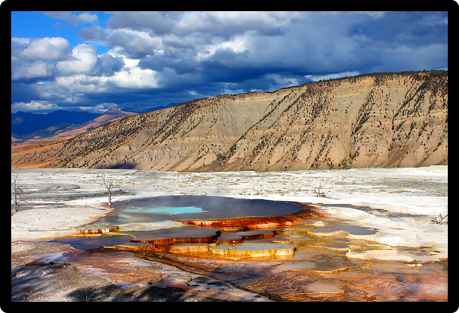 Evening sunlight shines on Canary Spring of the Mammoth Hot Springs in Yellowstone National Park.