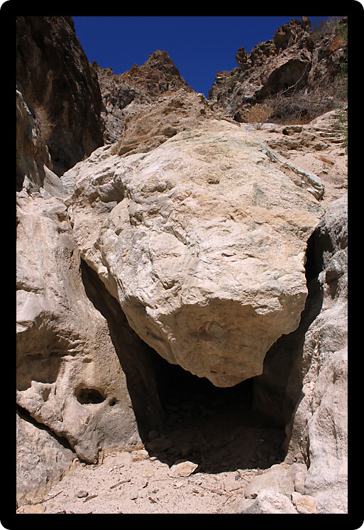 Large boulder wedged in desert rock in Grapevine Canyon Nevada.