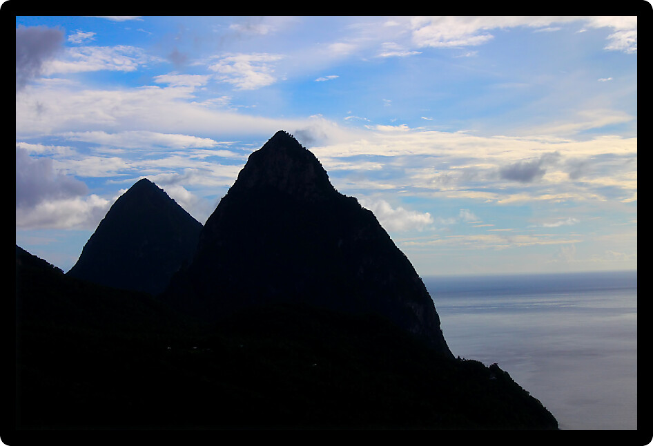 Famous Pitons of Saint Lucia silhouetted against the sky.