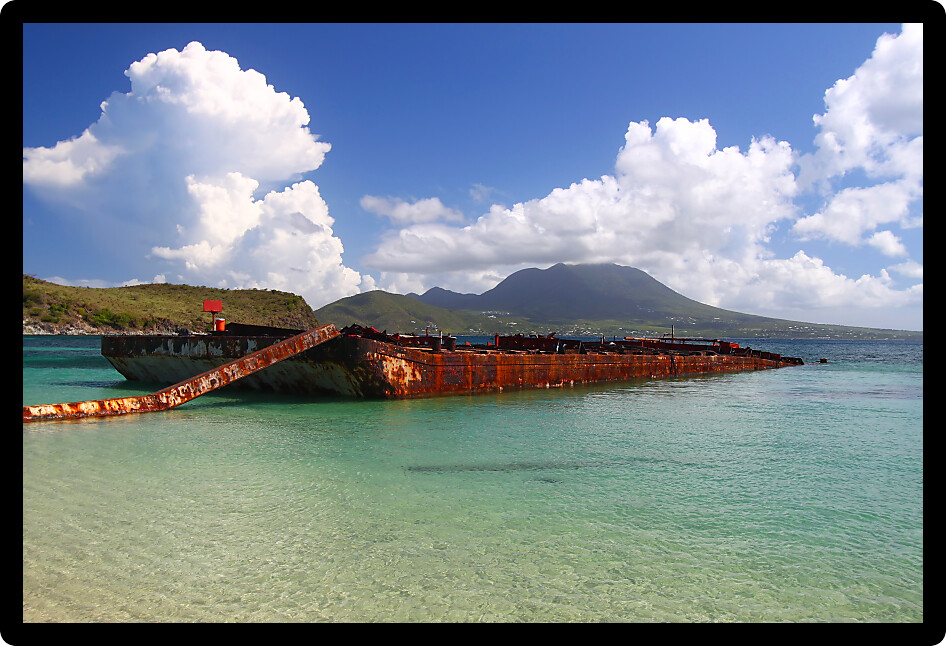 Wrecked barge serves as a makeshift fishing pier in Majors Bay Saint Kitts.