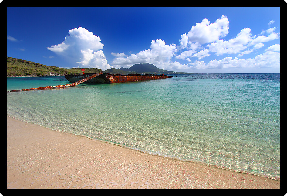 Wrecked barge serves as a makeshift fishing pier in Majors Bay Saint Kitts.