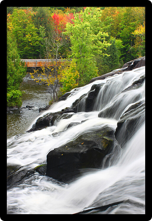 Autumn foliage surrounds the cascading waters of Bond Falls in northern Michigan.