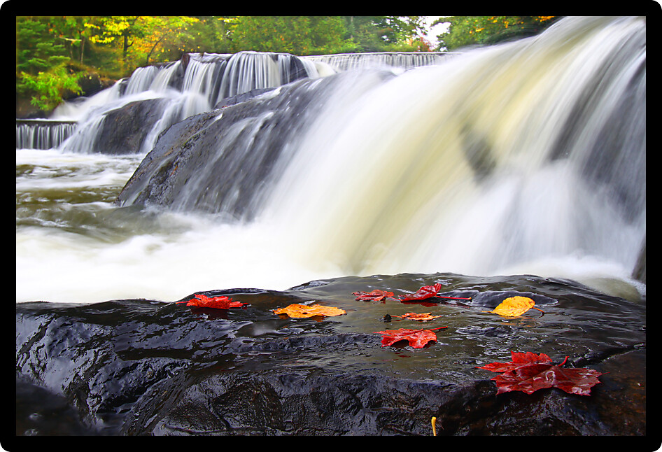 Autumn foliage surrounds the cascading waters of Bond Falls in northern Michigan.