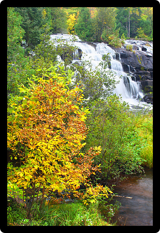 Autumn foliage surrounds the cascading waters of Bond Falls in northern Michigan.