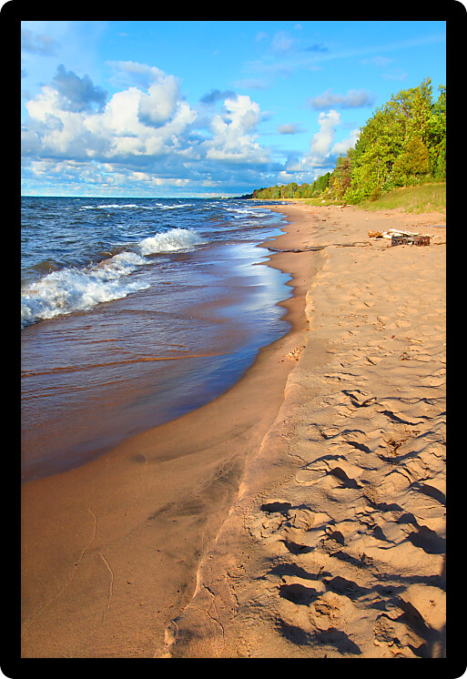 Waves along the beach of Lake Superior in northern Michigan under beautiful sunlight.