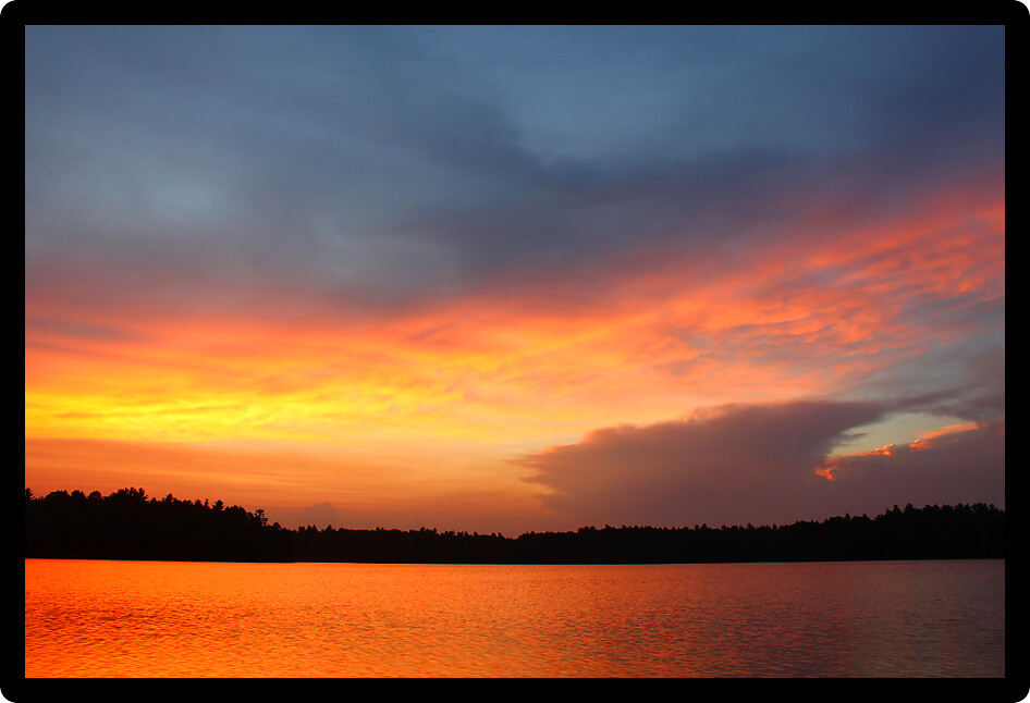 Brilliant colors of sunset over a northwoods Wisconsin Lake.