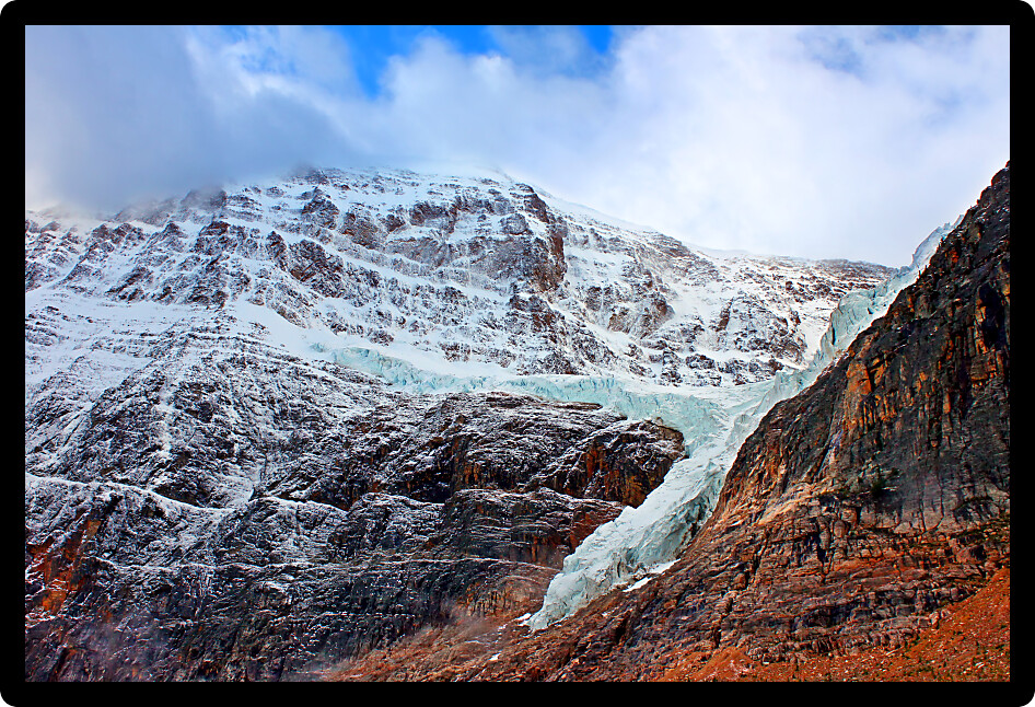 Angel Glacier hangs over a cliff below Mount Edith Cavell in Jasper National Park Canada.
