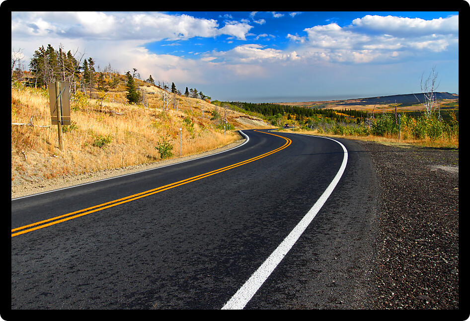 Winding road through the rural countryside of Glacier County Montana.