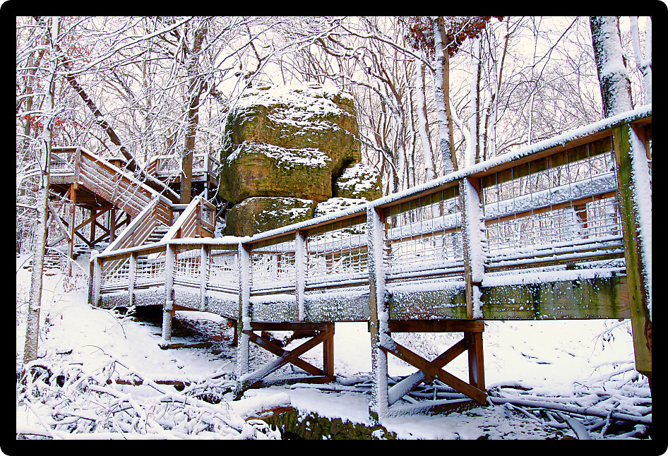 Big Rock at Rock Cut State Park in a snow covered forest.