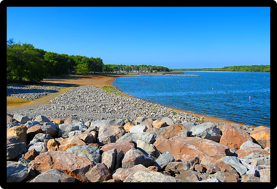 Rocky southern shoreline and swimming beach of Carlyle Lake in Illinois.