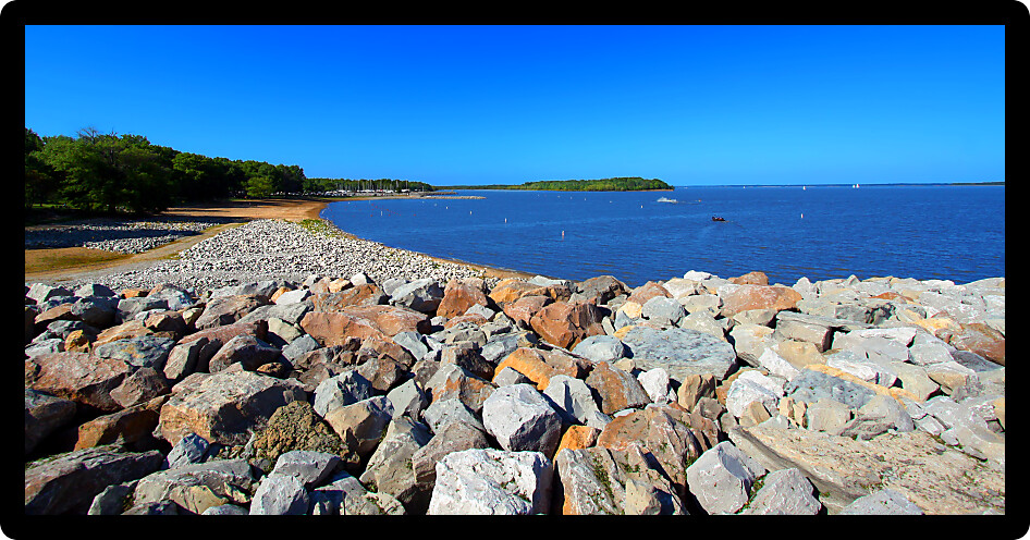 Rocky southern shoreline and swimming beach of Carlyle Lake in Illinois.