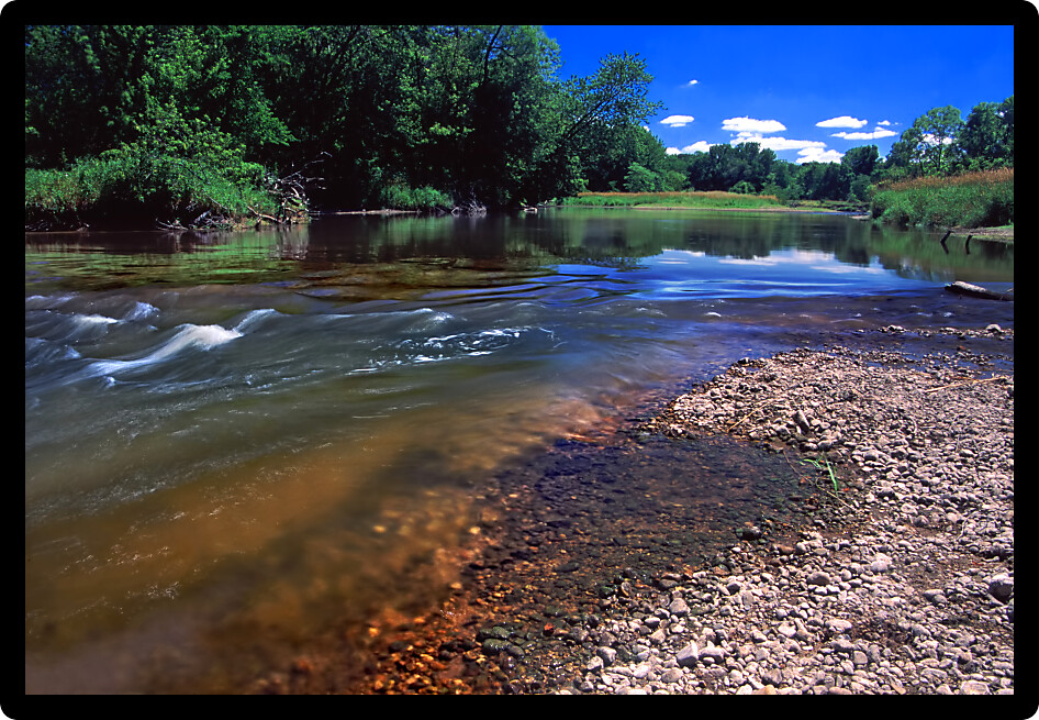 Swift current of the Kishwaukee River in Boone County Illinois.