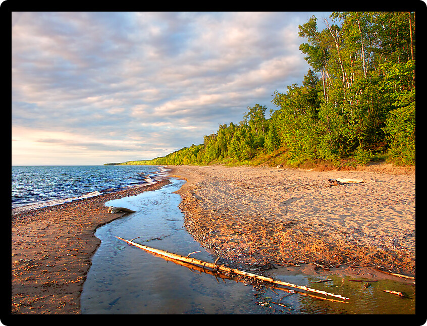 Sandy shoreline of Lake Superior on a beautiful summer evening.
