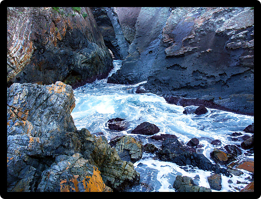 Waves crash through The Slot at Seal Rocks in New South Wales Australia.