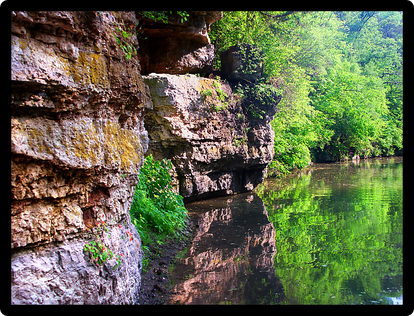 Cliffs and forest scenery reflecting off Yellow Creek at Krape Park in Illinois.