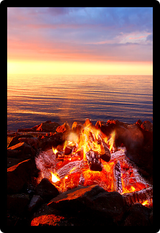Sunset camp fire along the beautiful beach of Lake Superior in northern Michigan.