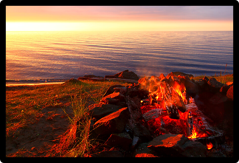 Sunset camp fire along the beautiful beach of Lake Superior in northern Michigan.