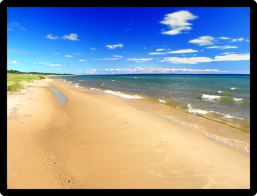 Lake Michigan beach on a warm summer day seen from the Upper Peninsula of Michigan.