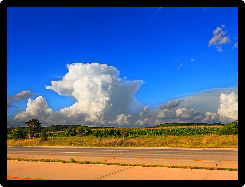 Cumulonimbus clouds of a supercell thunderstorm over the farmlands of Rock County Wisconsin in the summer of 2015.