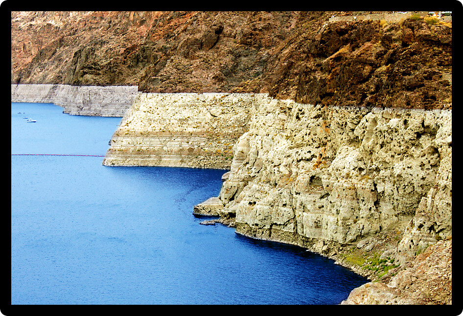 Steep rocky shoreline of Lake Mead seen from the Hoover Dam east of Las Vegas Nevada.