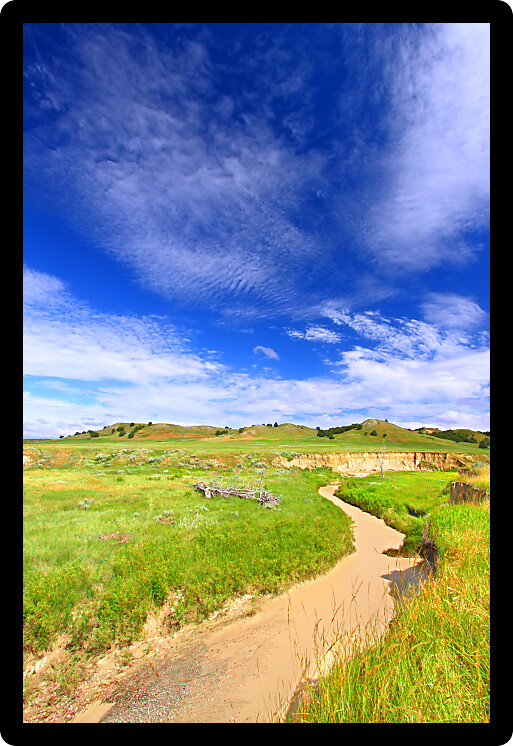 Calm waters flow through Sage Creek in Badlands National Park of South Dakota.
