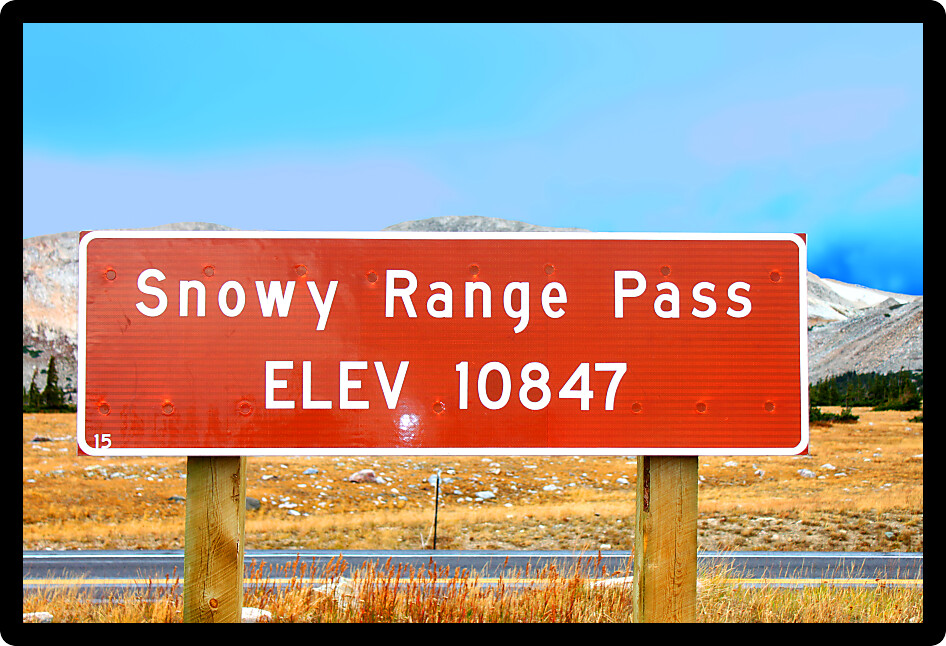 Sign highlighting the high altitude of Snowy Range Pass in the Medicine Bow National Forest of Wyoming.