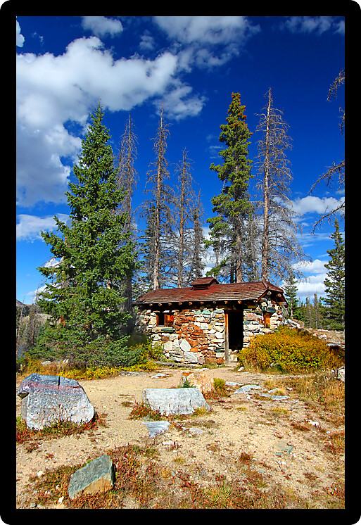 Rustic mountain cabin landscape in the Medicine Bow National Forest of Wyoming.