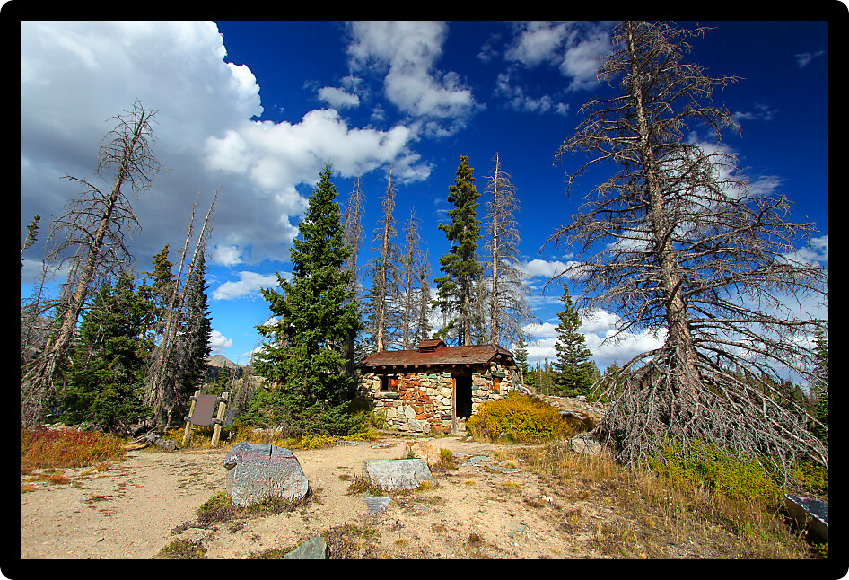 Abandoned mountain cabin atop a hill in the Medicine Bow National Forest of Wyoming.