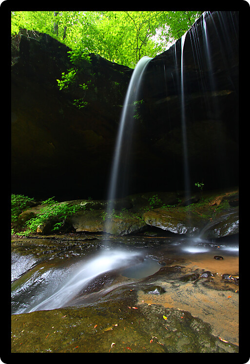 Waterfall flows into a deep canyon in the woodland of northern Alabama.