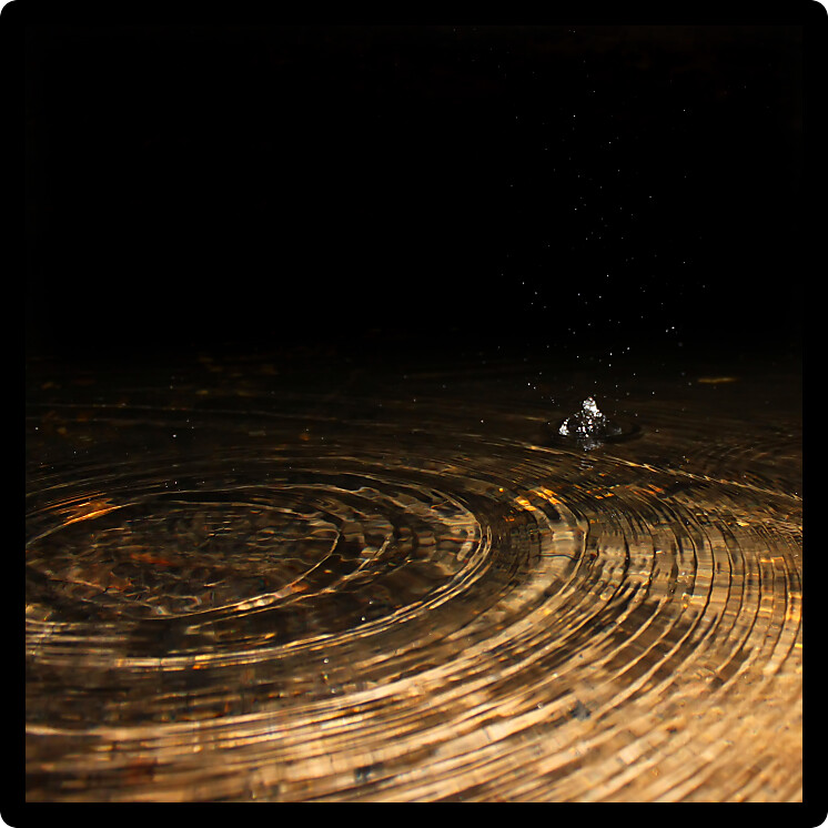 Small drops waken the surface of a small pool in Cave Spring along the Natchez Trace Parkway of northern Alabama.