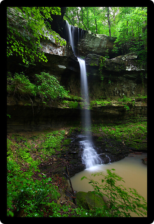 Waterfall flows into a deep canyon in the woodland of northern Alabama.