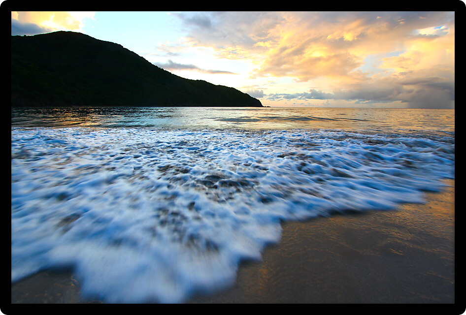 Calm waves wash ashore at Brewers Bay on Tortola British Virgin Islands.