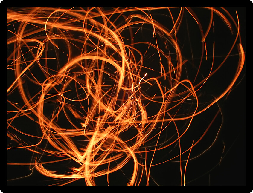 Vivid whirl of flame and sparks light up the night.