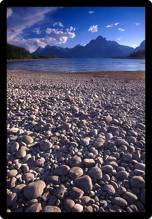 Jackson Lake shoreline catches the last rays of sunlight at Grand Teton National Park in Wyoming.