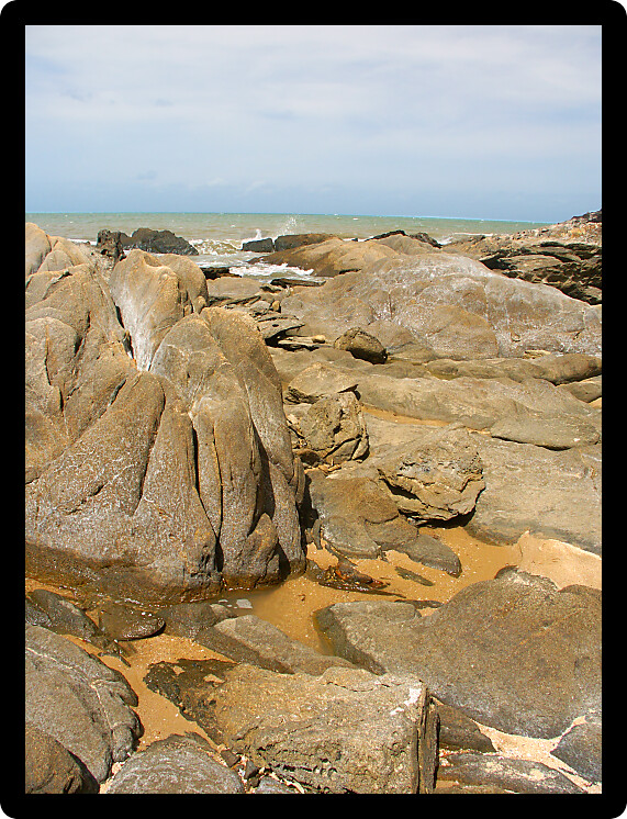 Boulders dot the coast near Trinity Beach of Cairns in Queensland Australia.