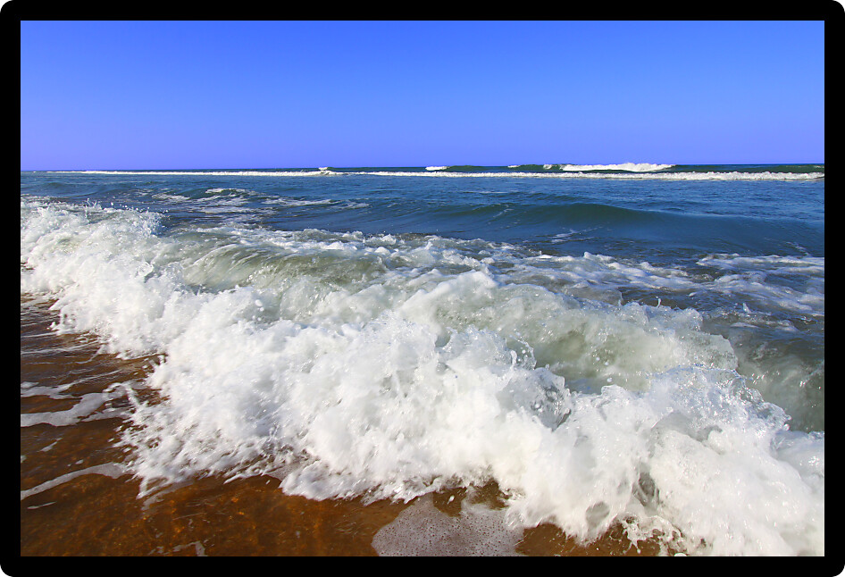 Waves crash along the coast on a beautiful day in Daytona Beach Florida.