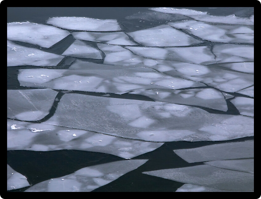 Large pieces of ice float down the Illinois River.