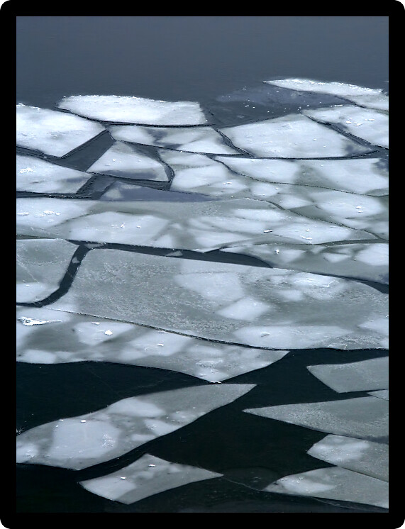 Large pieces of ice float down the Illinois River.