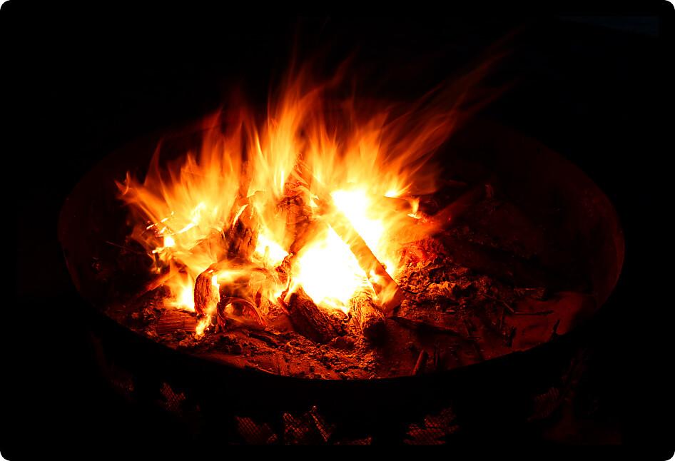 View of a blazing campfire in the dark night.