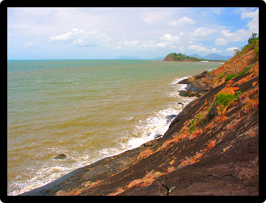 Dark cliffs at Trinity Beach north of Cairns in Queensland Australia.