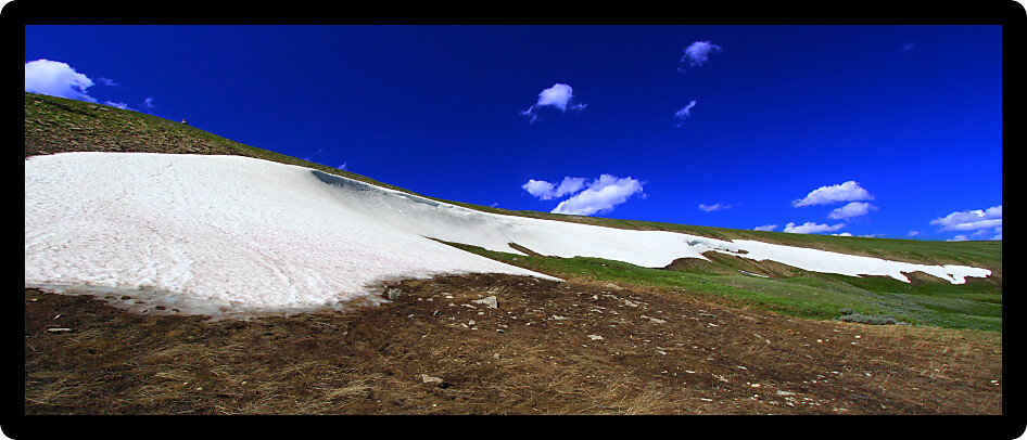 Snow lingers in the high elevations of the Bighorn Mountains on a sunny summer day.