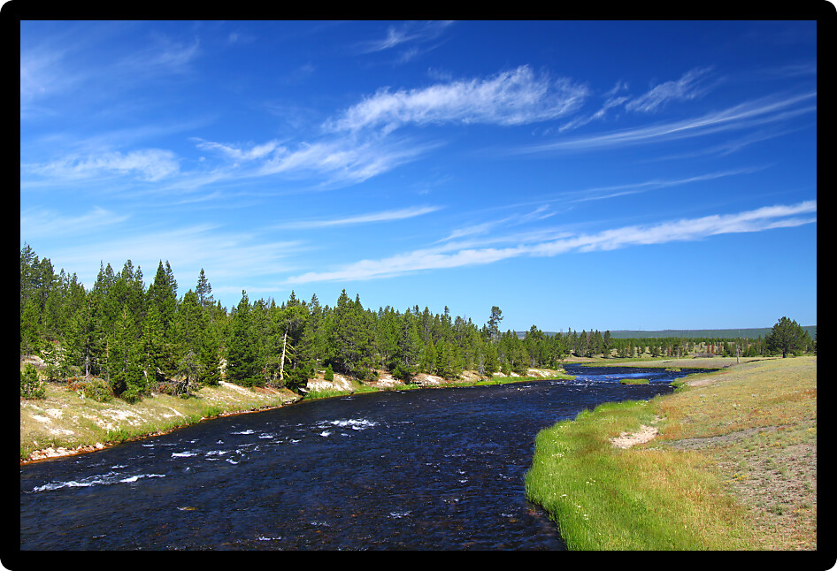 Firehole River flows through Yellowstone National Park on a beautiful sunny day.
