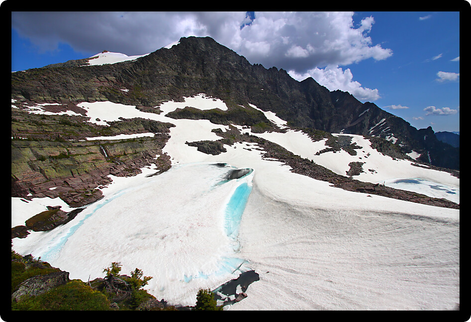 Frozen lake below Sperry Glacier in Glacier National Park USA.