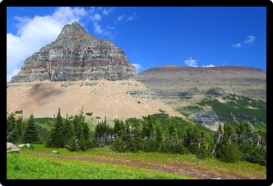 Jagged peaks rise from the ground at Logan Pass of Glacier National Park Montana.
