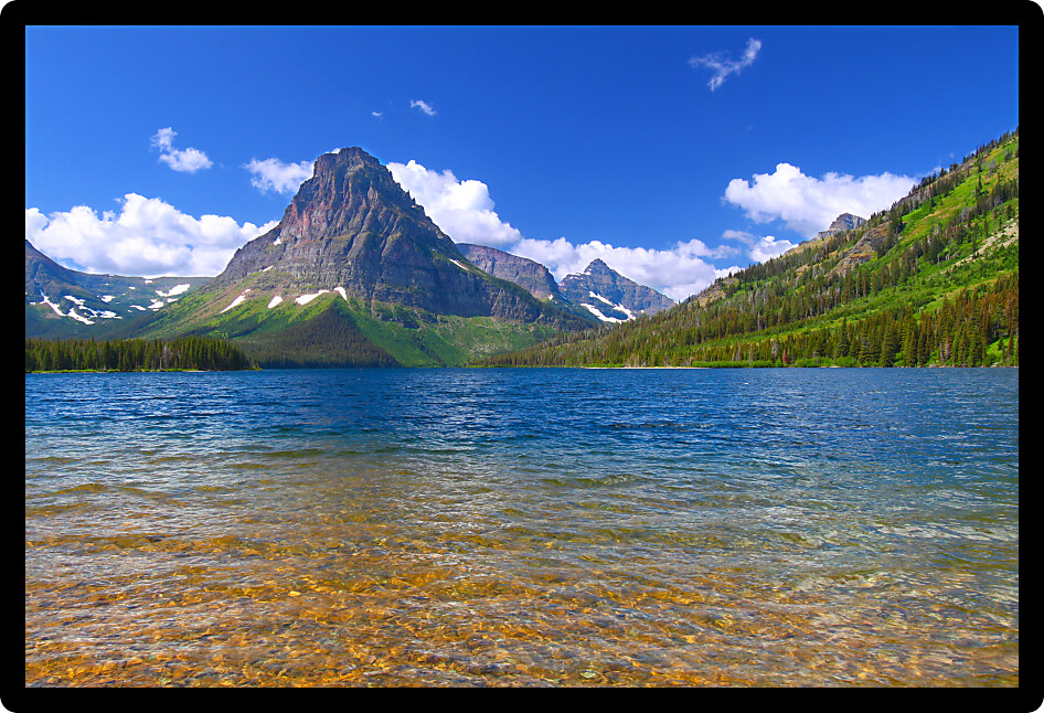 Mount Sinopah rises over Two Medicine Lake on a gorgeous summer day in Glacier National Park.