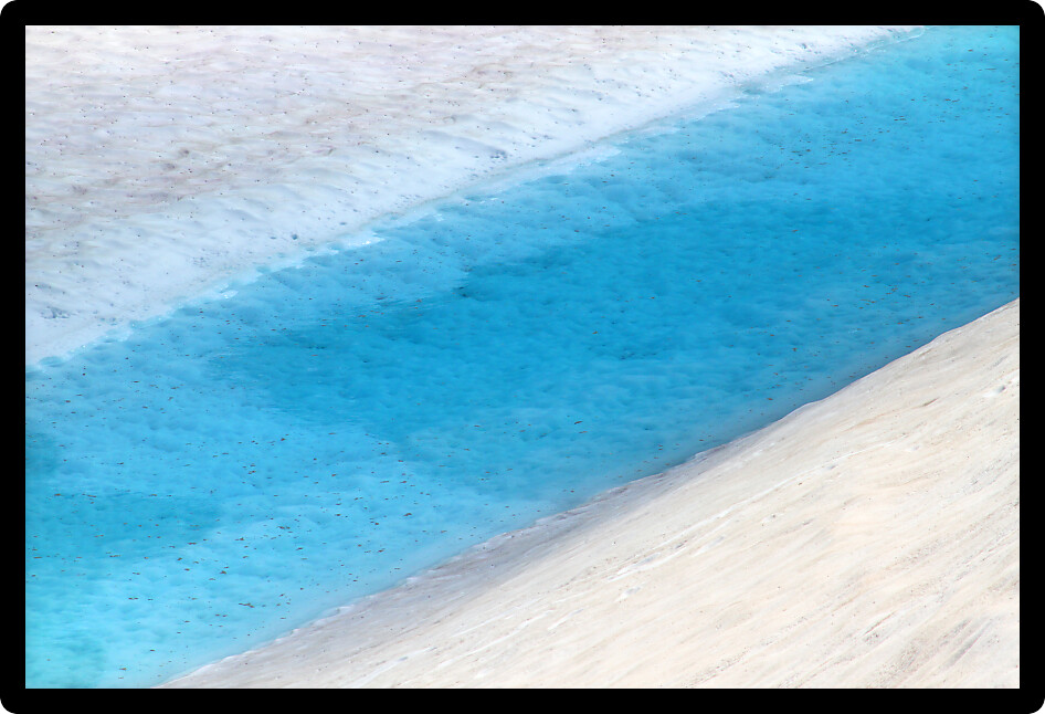 Small blue pool formed from meltwater near Sperry Glacier in Montana.