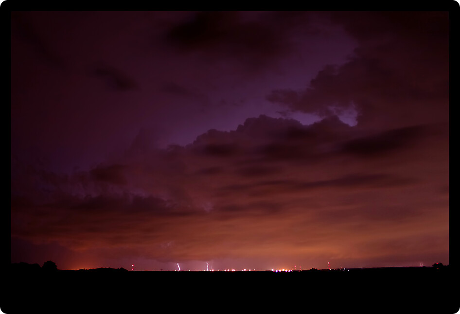 Lightning strikes the ground from a distant summer thunderstorm in Illinois.