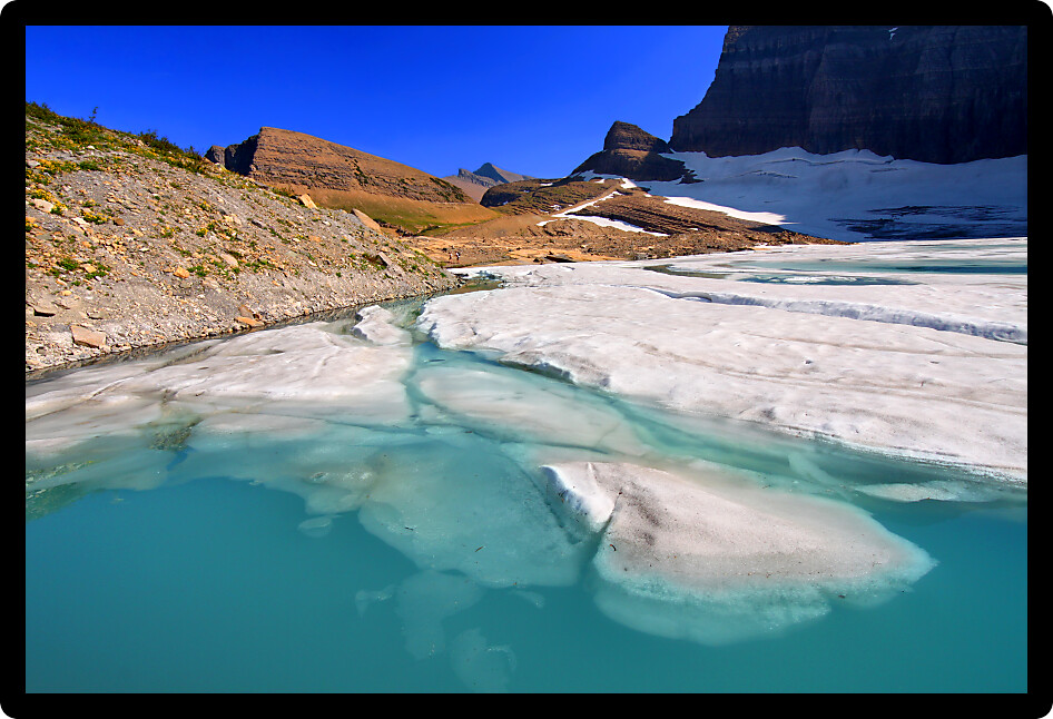 Ice floats in a pond by the Grinnell Glacier in Glacier National Park of Montana.