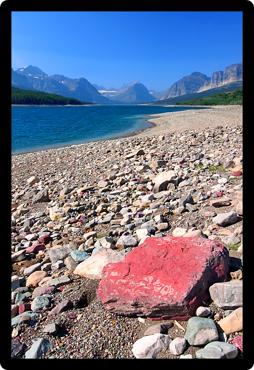 Rocky shoreline of Lake Sherburne in Glacier National Park of Montana.