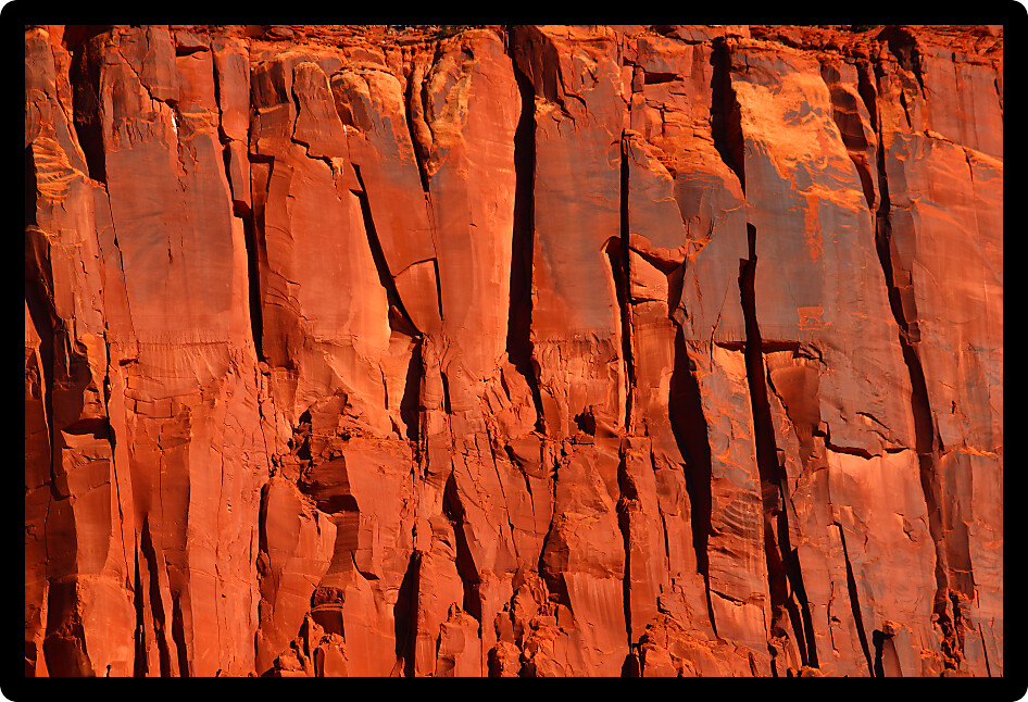 Bright red rock cliff in the rugged backcountry of Utah.